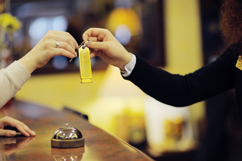 business woman  at the reception of a hotel checking in